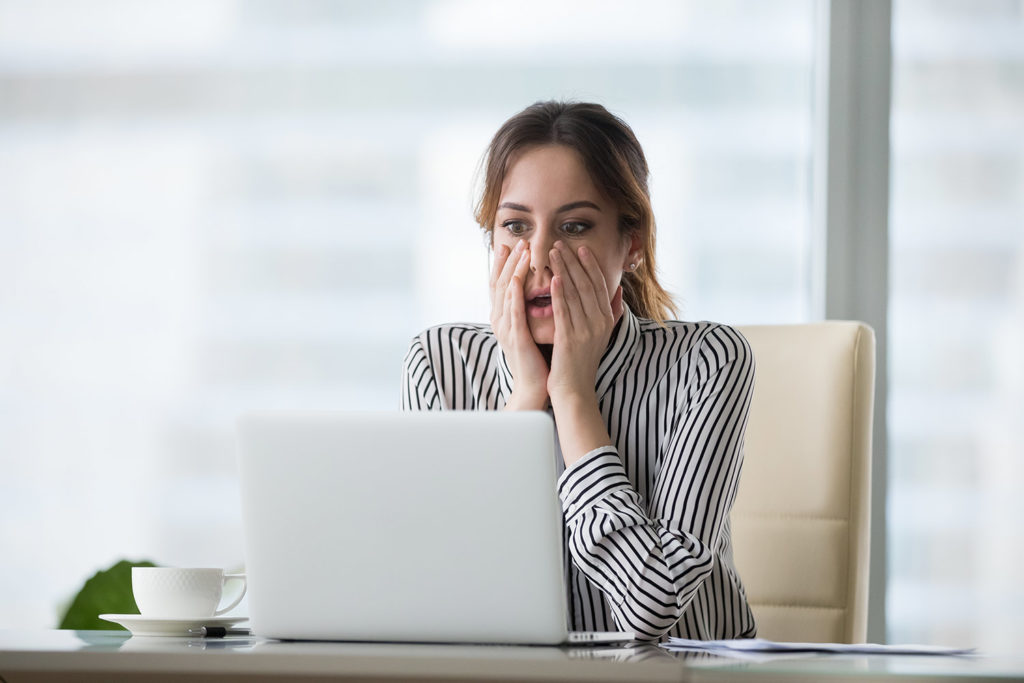 lawyer reading shocking news on a laptop