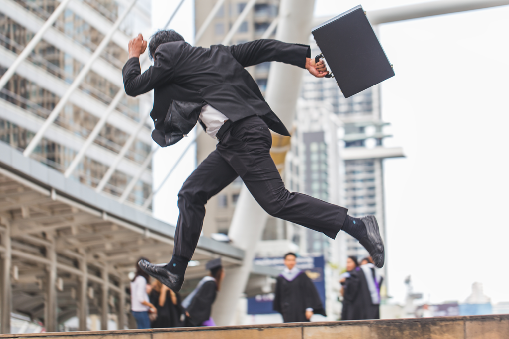 lawyer running with briefcase through city
