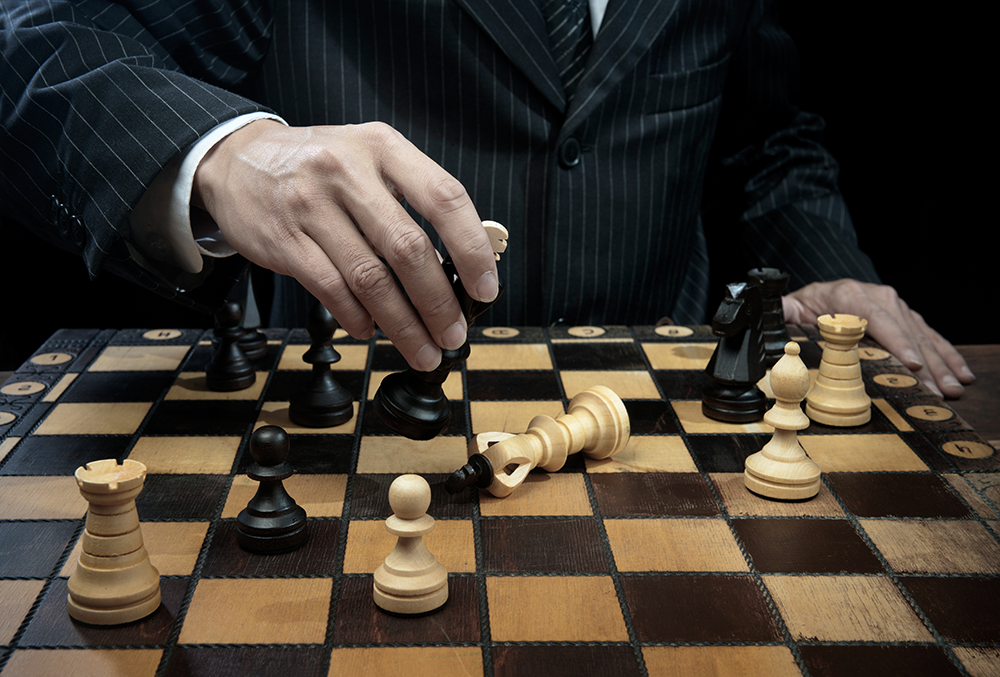 man in pinstriped suit winning chess match