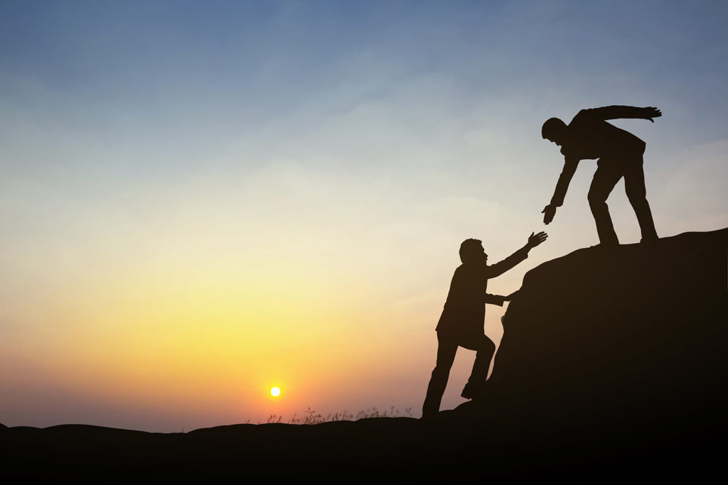 silhouttes of a lawyer offering a hand to another lawyer