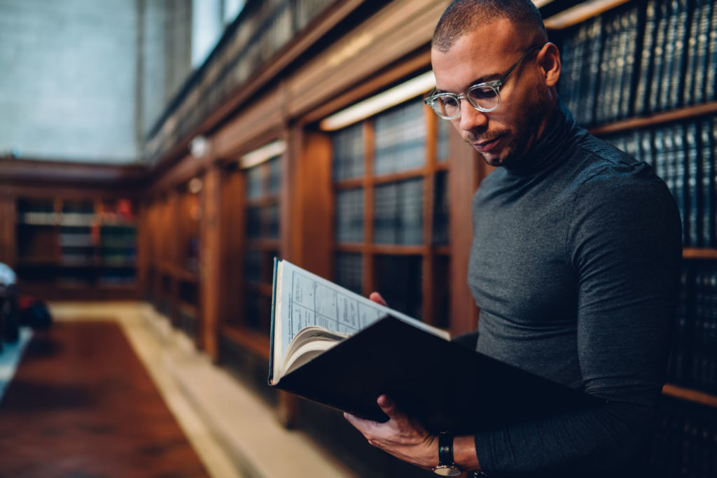 lawyer reading book in a law library