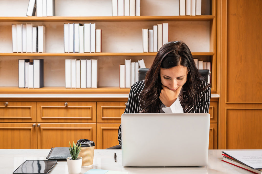 lawyer gazing at laptop in deep thought