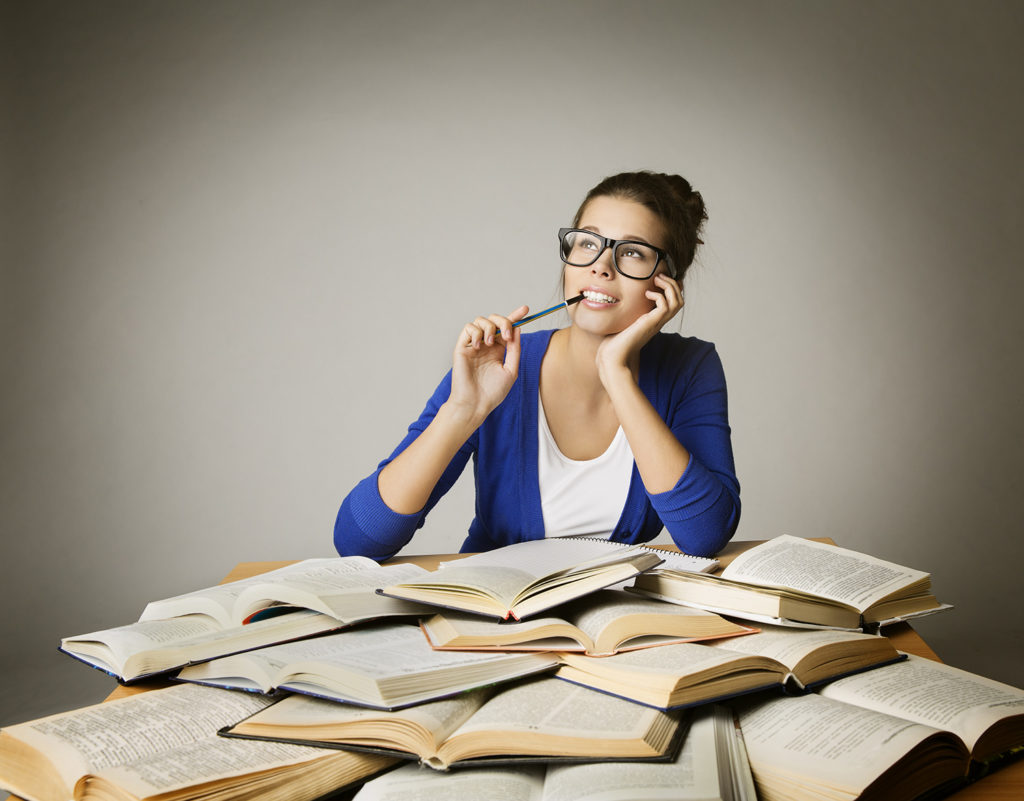 lawyer thinking over a pile of open books