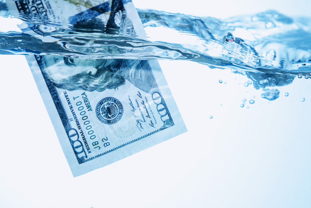 $100 bill floating in water