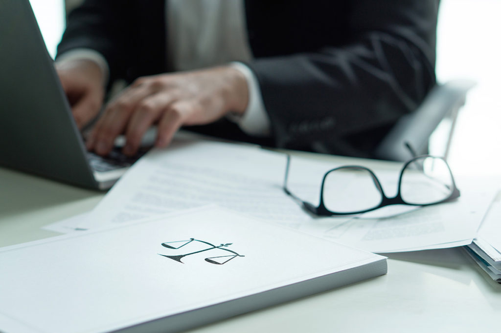 attorney writing a brief on a laptop