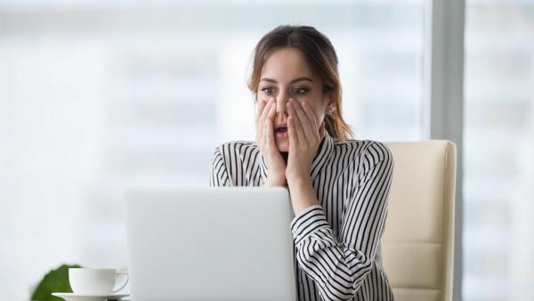lawyer reading shocking news on a laptop