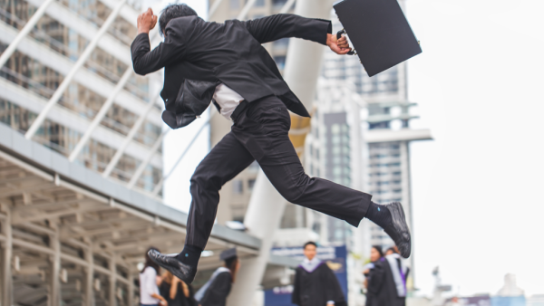 lawyer running with briefcase through city