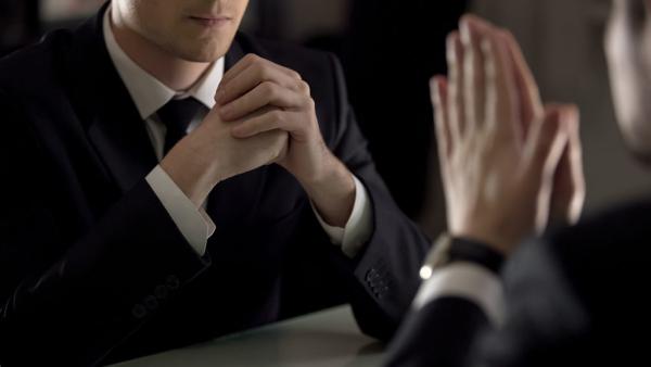 two people facing each other in discussion