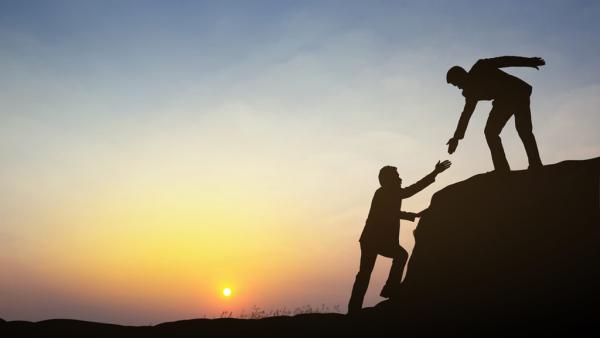 silhouttes of a lawyer offering a hand to another lawyer