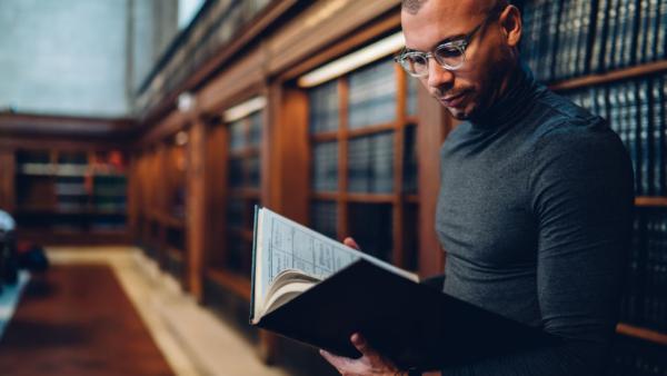 lawyer reading book in a law library