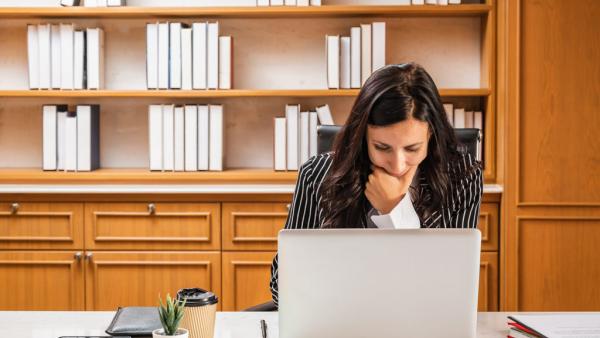 lawyer gazing at laptop in deep thought