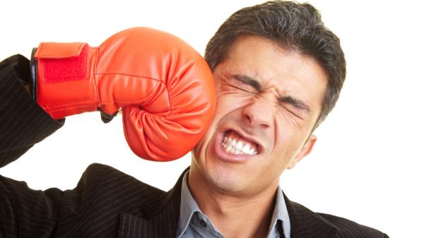 attorney wearing a boxing glove, punching himself in the cheek