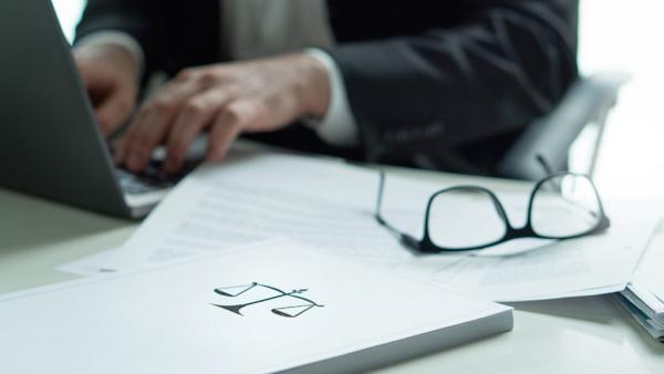 attorney writing a brief on a laptop