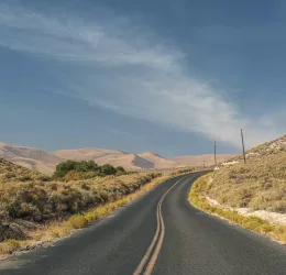 photo of road with California landscape background