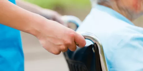 Nurse assisting patient in wheelchair