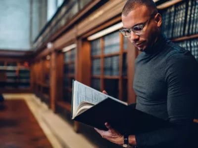 lawyer reading book in a law library