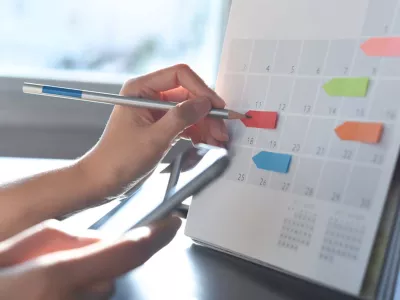 person using a calendar to mark important dates